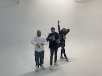 three people posing in a white studio