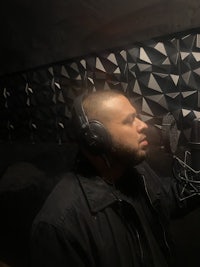a man wearing headphones in a recording studio