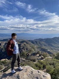a man standing on top of a rock
