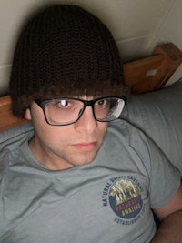 a man wearing glasses and a beanie