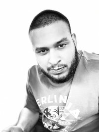 a black and white photo of a man with a beard