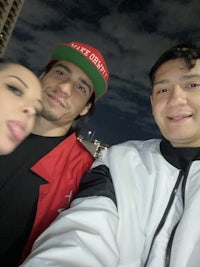 three people posing for a selfie at night